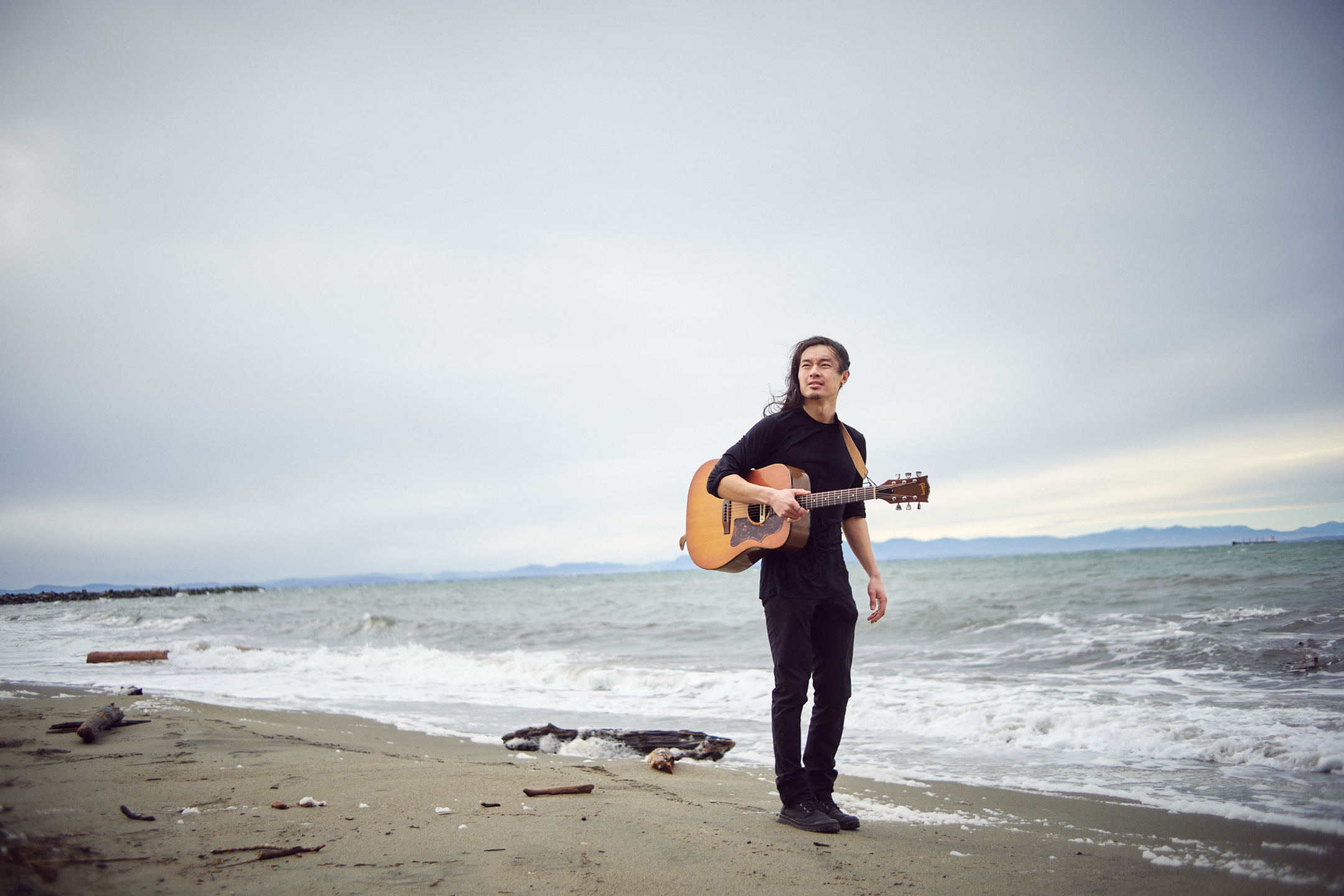 Portrait of Daniel Lew on the beach.